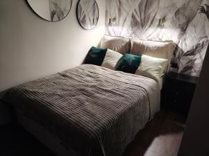 a bedroom with a bed with pillows and a mirror at Studio 27 in Zabrze