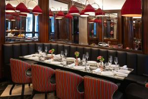 a dining room with a long table and chairs at Hotel d’Inghilterra Roma – Starhotels Collezione in Rome