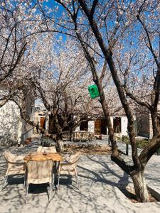Ein Tisch und Stühle stehen unter einem Baum in der Unterkunft MarNar Hotel in Yerevan