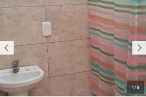 a bathroom with a sink and a shower curtain at Rodolfo in La Paloma