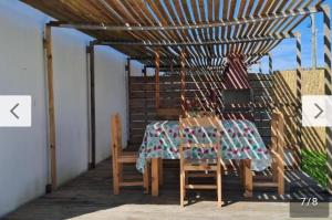 a table and chairs on a porch with a tablecloth at Rodolfo in La Paloma