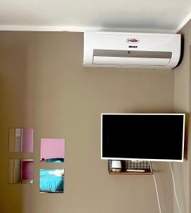a flat screen tv hanging on a wall at B&b cuore di casa in Ferno