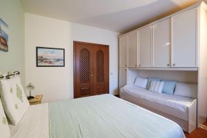 a bedroom with two beds and a cabinet at Cala Del Faro House in Arzachena