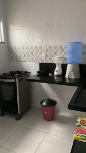 a kitchen with a stove and a counter top at Lar Aconchego climatizado e compartilhado in Aracaju