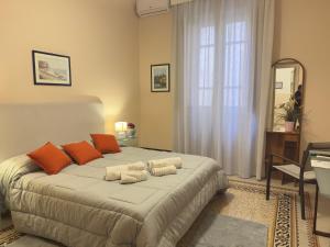 a bedroom with a large bed with orange and white pillows at L'Angolo di Palermo in Palermo