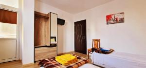 a bedroom with a bed and a chair in a room at Alex City Apartment Gabrovo in Gabrovo