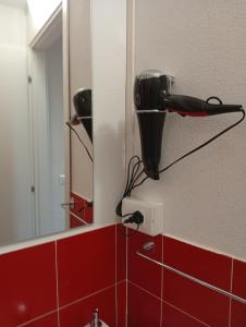 a bathroom with a hair dryer attached to a mirror at Appartamento rosso blu in Vernazza