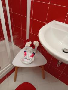 a small shelf in a bathroom with a sink and a pair of shoes at Appartamento rosso blu in Vernazza +9 photos