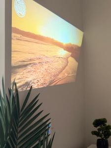 a picture of the beach on a wall at Apartament SLEEP&GO Ostrowiec Świętokrzyski in Ostrowiec Świętokrzyski