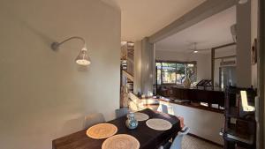 a dining room with a table and a kitchen at Villa Luce by Italy Home eXperience in Santa Marinella