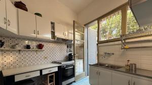 a kitchen with a sink and a stove at Villa Luce by Italy Home eXperience in Santa Marinella +7 photos