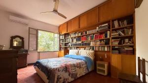 a bedroom with a bed and a book shelf at Villa Luce by Italy Home eXperience in Santa Marinella