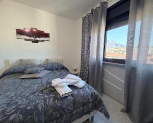a bedroom with a bed with towels on it at Casa Baccanico - a due passi da autostazione in Avellino