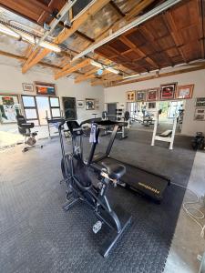 a gym with cardio equipment in a room at Uys Cottage on 79 in Heidelberg