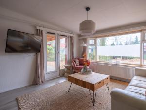 a living room with a couch and a coffee table at Ermmoon Cottage in Erm