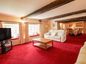 a living room with a couch and a coffee table at The Farmhouse in Keswick