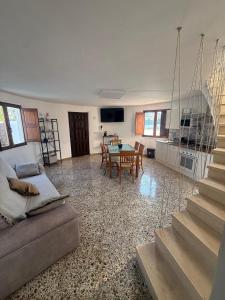 a living room with a table and a dining room at El Molino de Valverde in Elche