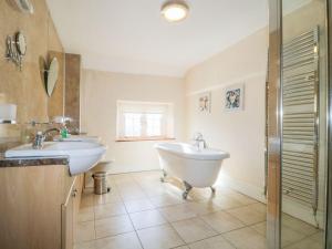 a bathroom with two sinks and a tub at The Farmhouse in Keswick +19 photos