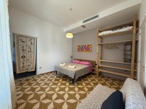 a room with a bed and bunk beds and a table at casa surano in Diso