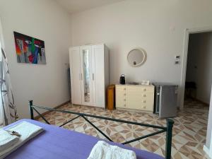 a bedroom with a bed and a dresser and a mirror at casa surano in Diso +20 photos