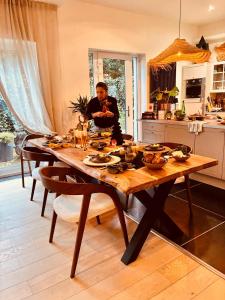 a man sitting at a table in a kitchen at Si brugge in Bruges