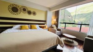a bedroom with a large bed and a large window at Ayra Hotel Boutique in Pisac