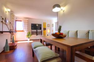 a living room with a table and a couch at 20 passi dalla spiaggia - Panoramic Duplex in Porto Rotondo