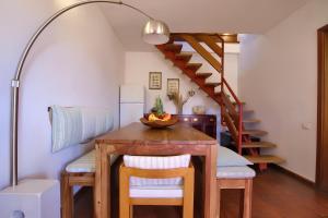 a dining room with a table and a staircase at 20 passi dalla spiaggia - Panoramic Duplex in Porto Rotondo +41 photos