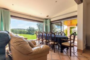 a dining room with a couch and a table and chairs at Casal do Aviador in São Vicente do Paul