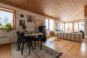 a dining room and living room with a table and chairs at Tromsø Panorama in Tromsø