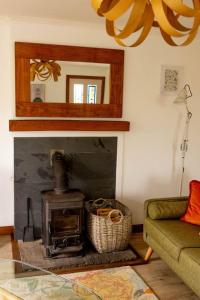 a living room with a fireplace and a couch at Evrabister, Shetland Islands in Mainland