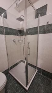 a shower with a glass door in a bathroom at La casa sul molo - Acquario in Genoa +21 photos