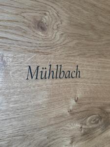 a wooden table with the word mililliack written on it at Gästehaus Johannes in Niedernsill