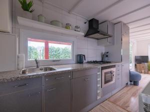 a kitchen with stainless steel appliances and a window at Ermway Cottage in Erm