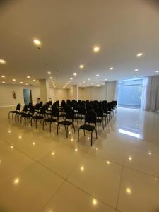 a large room with chairs and a screen in it at Samba Rio Bonito in Rio Bonito