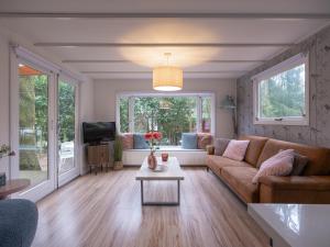 a living room with a couch and a table at Ermway Cottage in Erm