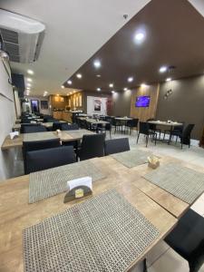a dining room with tables and chairs and tablesktop at Samba Rio Bonito in Rio Bonito