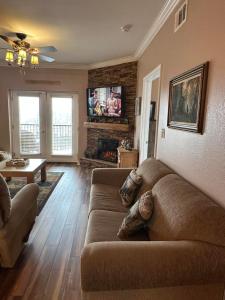a living room with a couch and a fireplace at Mountain View Condo 3702 in Pigeon Forge