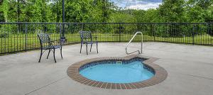 a patio with two chairs and a small pool at Mountain View Condo 3702 in Pigeon Forge