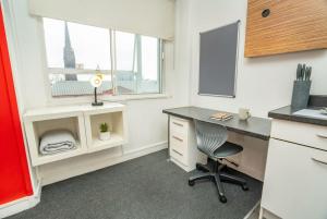 an office with a desk and a chair and a window at Spacious & Bright Central Coventry Budget Studio in Coventry