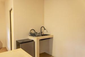 a small table with a lamp on it in a room at La Punta SurfHouse in Brisas de Zicatela
