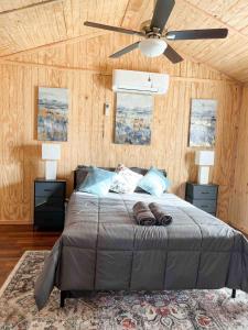 a bedroom with a bed with a ceiling fan at Big Bass Bungalow - Quitman Tx in Quitman