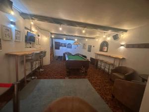 a billiard room with a pool table and a bar at Manor Inn Galmpton in Brixham