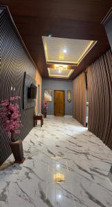 a lobby with a large marble floor and a door at MH Villa Deluxe Twin in Pancor