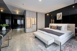 a bedroom with a white bed and a black wall at Hotel AP in Kalisz