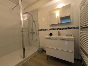 a white bathroom with a sink and a shower at Spacious Quiet Pyrenees View Garage in Pau