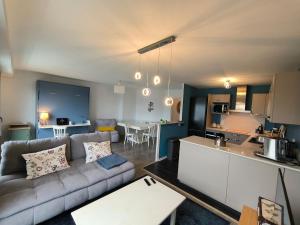 a living room and kitchen with a couch and a table at Spacious Quiet Pyrenees View Garage in Pau