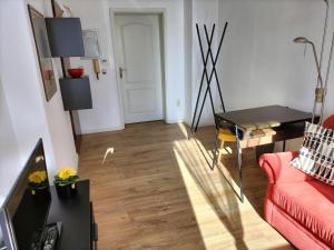 a living room with a red couch and a table at Eulennest-lu in Ludwigshafen am Rhein