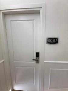 a white door with a sign that says roma on it at Emy Suites in Civitavecchia