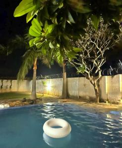 a white toilet in a swimming pool at night at The Casa Bella in Faridabad +7 photos